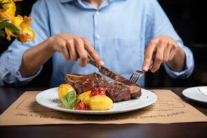 man eating steak