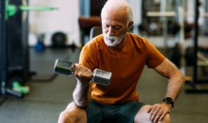 older man lifting weights