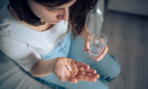 woman taking pill